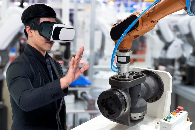 Virtual reality technology in industry 4.0. Business man suit wearing VR glasses to see AR service , Thermal Monitoring motor for check destroy part of smart robot arm machine in smart factory